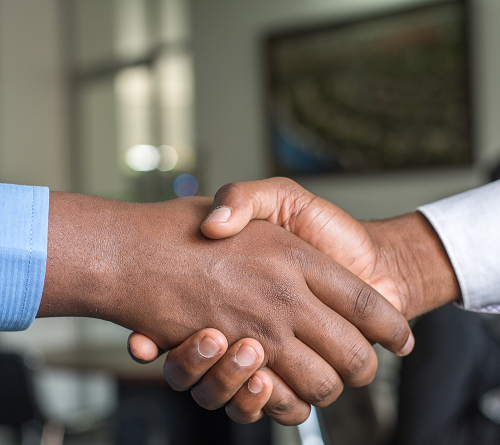 Image of two hands in a standard business handshake